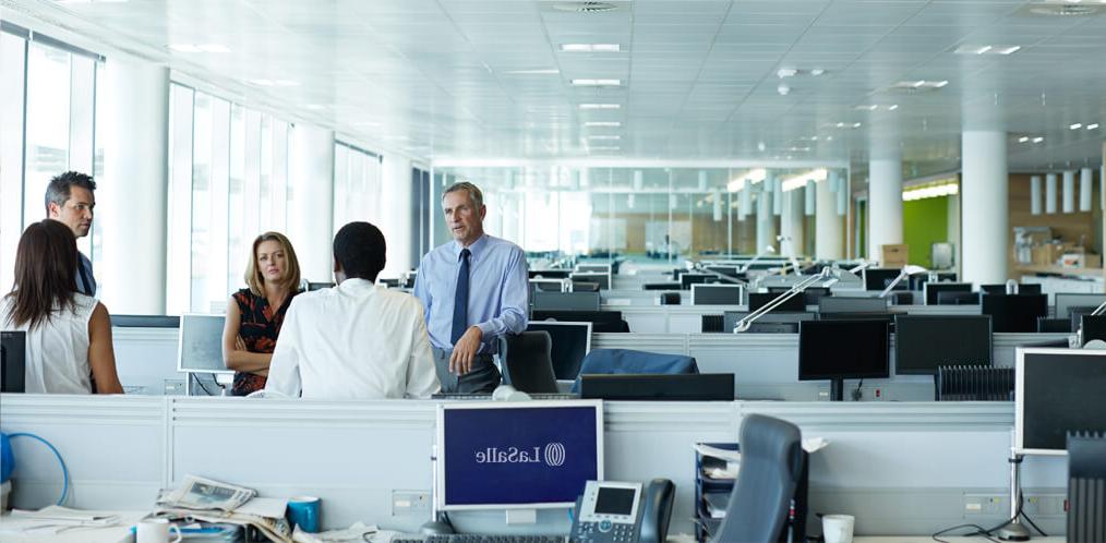 Employees talking in an open space office